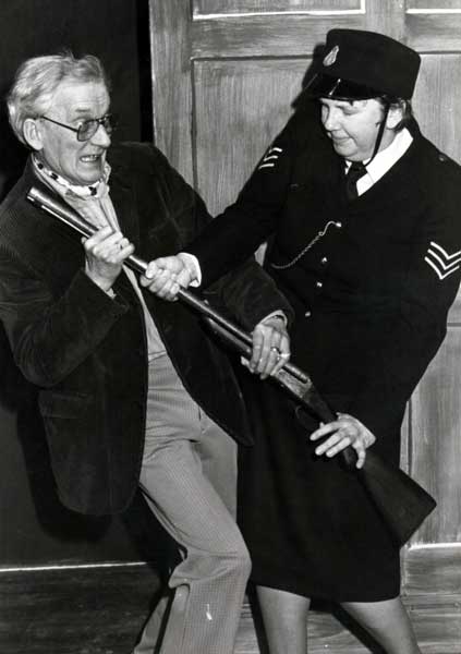 Col. Wagstaffe (Ted Younghusband) struggles with Sergeant Fire (Margaret Yearsley) for the shotgun!