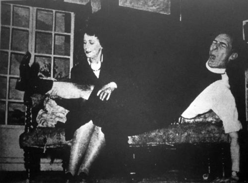 Miss Skillon (Mary Brown) renders first-aid to the Vicar's injured knee