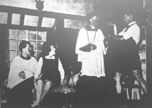 The VIcar in emergency attire asks the Rev. Humphrey (I. Mc C. Bell) to help him check his pools in the potting shed, watched by Willie D.A. Collins) and Ida