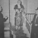 Clem Hayes (played by Alex Penn) is about to shoot Rudge (played by Laurie Clark). Watching the execution is Madam Tic-Tac (played by Ann Dickens)