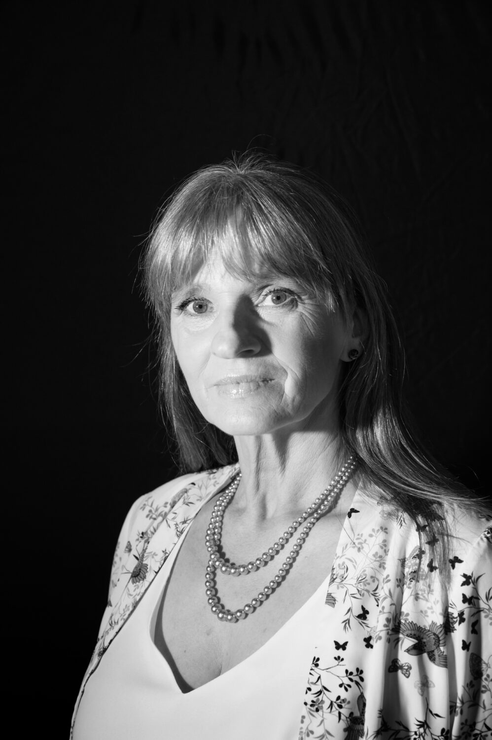 Sarah Delorme plays NORA BATTY