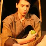 Jim (Emily-rose Lane) hides in the apple barrel