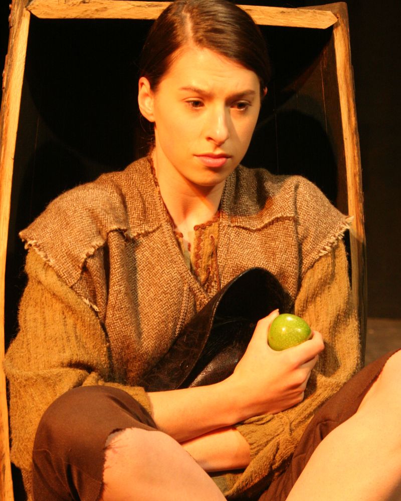 Jim (Emily-rose Lane) hides in the apple barrel